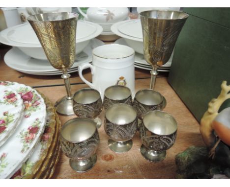 Six plated egg cups and two similar wine goblets etc