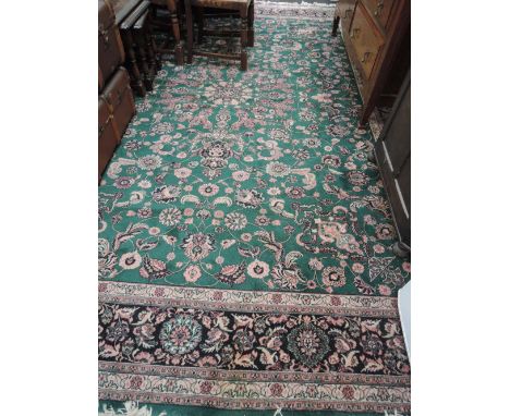 A large Chinese style carpet square having green ground