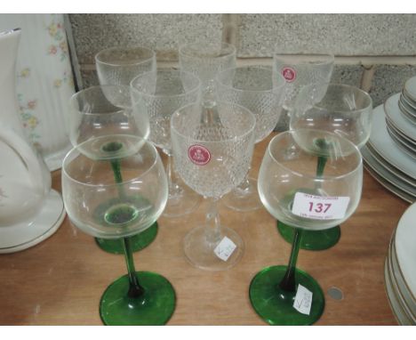 A set of Royal Albert lead crystal wine glasses and four green stemmed wine glasses