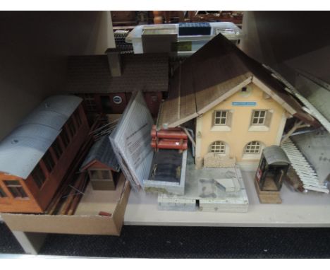 A shelf of G scale accessories and building including model of Warton Dorf station, telegraph poles etc