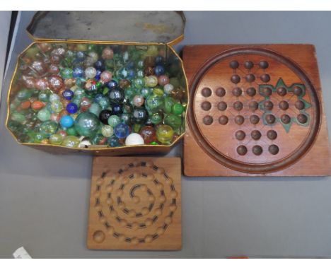 A selection of vintage marbles and a mahogany solitaire board and a similar board