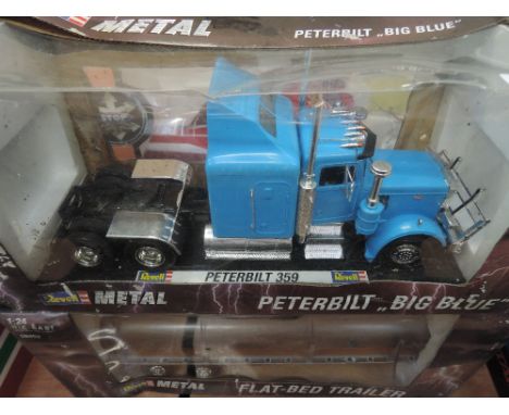 A Revell 1:24 scale diecast Peterbilt tractor unit and flat bed trailer, both boxed