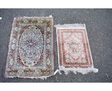 A Persian silk prayer rug having floral decoration; together with a smaller example, largest 88 x 62cm. 
