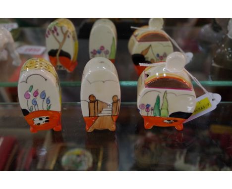 A Clarice Cliff three piece cruet set.  Condition Report: Several small chips on lid of mustard. Two chips on/around salt pou