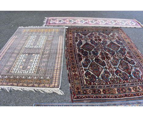 An Eastern rug having geometric field; together with another rug having geometric field and two other rugs, largest 208 x 152