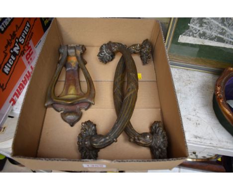 A pair of classical style brass handles; together with an Art Nouveau brass door knocker. 