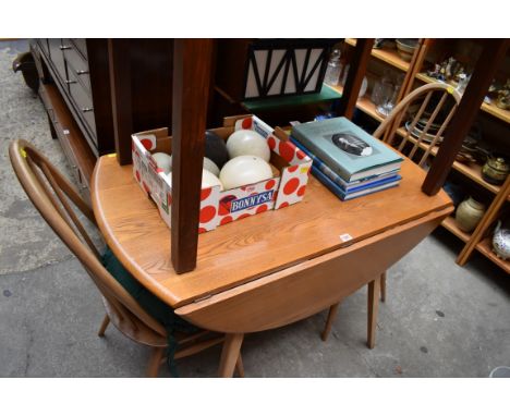 An Ercol drop leaf table, 108cm wide; together with a set of four Ercol dining chairs. 