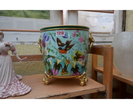 A Continental porcelain twin handled tripod jardiniere, 23cm high.  Condition Report: No makers mark on this item.  Rubbing t