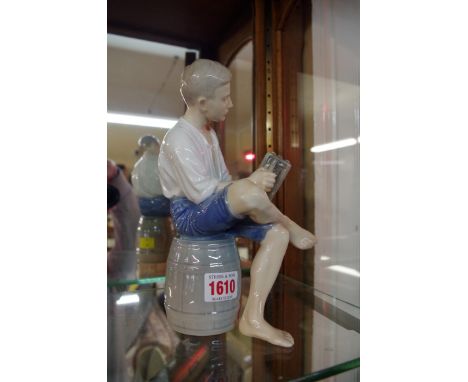 A Bing and Grondahl figure of a young man with a piano-accordion, 22cm high. 