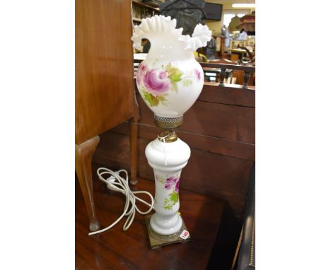 An opaque glass table lamp, painted with flowers and inscribed signature, total height 60cm. 