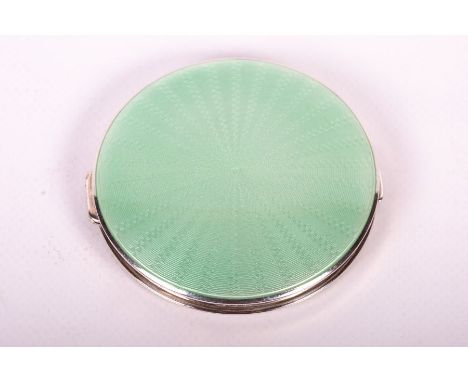 A pale green guilloche enamel topped compact in sterling silver Hallmarked for Adie Brothers Ltd, Birmingham 1951. The enamel