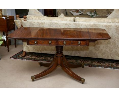 A George IV mahogany sofa table circa 1820, rounded rectangular, fluted angles, two real and two dummy drawers with lion mask