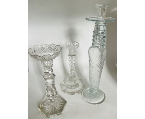 A George III style glass candlestick with facetted stem and petal base. 24.5cm high. a similar candlestick with hexagonal bas