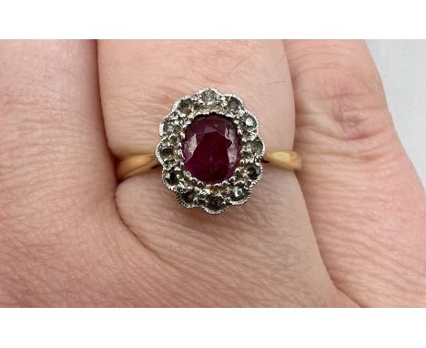 A 1920s-1930s ruby and diamond cluster ring. In yellow metal. Gross weight approximately 2.2 grams. Size M.