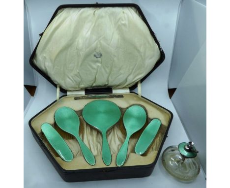 An Art Deco silver and green enamelled dressing table set comprising hand mirror , pair of hairbrushes , pair clothes brushes