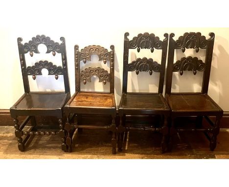 Four similar Charles II oak dining chairs, circa 1660-1680, arch splats with scrolling carving with acorn finials, two raised