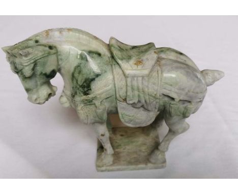 A Jade carving of a war horse 21cm long, 16cm high, 7.5cm wide.