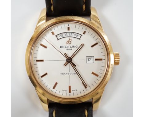 A gentleman's 2013 18ct gold Breitling Transocean automatic day/date wrist watch, with baton numerals, on a Breitling leather
