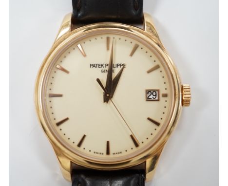 A gentleman's 2015 18ct gold Patek Philippe Calatrava automatic wrist watch, on a Patek Philippe leather strap with 18ct gold