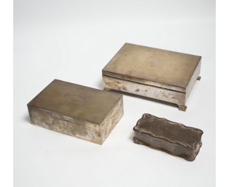 Two engine turned silver mounted cigarette boxes, the largest by Garrard & Co, London, 1955, 16.9cm and a silver trinket box.