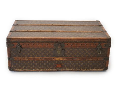 A vintage Louis Vuitton rectangular trunk, in monogram canvas with tan leather and brass mounted wooden slats, quilted interi