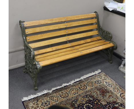 A Victorian Coalbrookdale 'nasturtium' pattern cast iron garden bench restored with later oak slats, length 146cm, depth 64cm