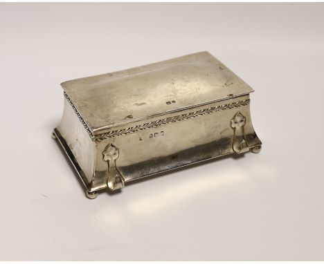 An Edwardian Arts and Crafts silver inkwell by Albert Edward Jones, with front pen rest and interior engraved inscription, Bi