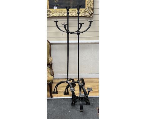 A pair of wrought iron three branch tripod pricket candlestands, height 146cm together with a matching four branch pricket ca