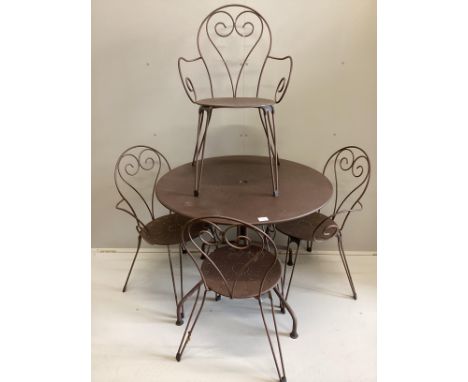A French circular painted wrought iron table, diameter 94cm, height 75cm together with four matching stacking chairs***CONDIT