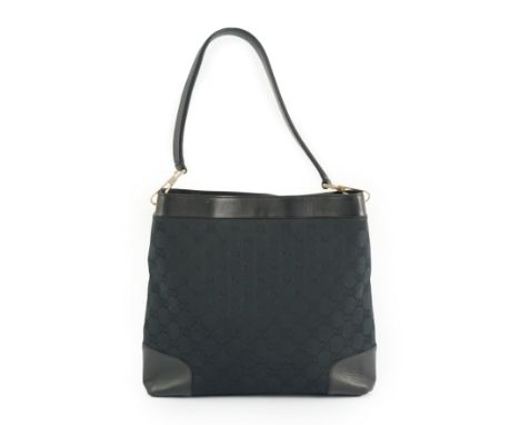 A Gucci black GG canvas shoulder bag with leather trim, leather strap, open top, and interior zip pocket, gold tone metal str