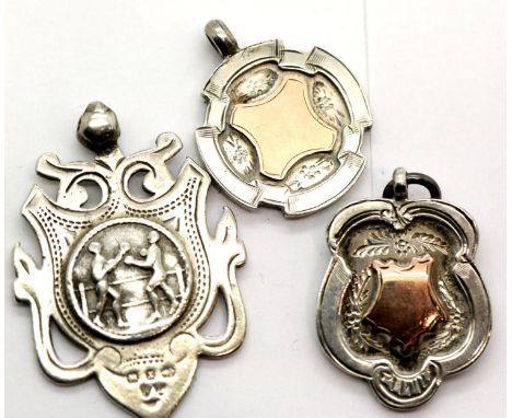 Three hallmarked silver fobs, two with gold shield to centre, total weight 31g. P&amp;P Group 1 (£14+VAT for the first lot an