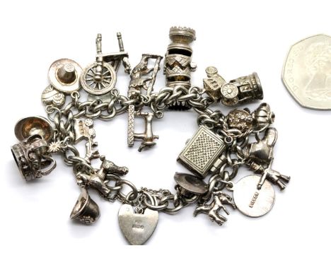 Sterling silver charm bracelet with 22 charms, approximately 84g total weight. Padlock hallmarked only. P&amp;P Group 1 (£14+