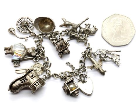 Sterling silver charm bracelet with 12 charms, 57g, padlock hallmarked silver. P&amp;P Group 1 (£14+VAT for the first lot and