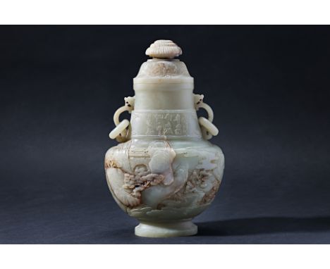 A CARVED JADE TWIN HANDLED VASE AND COVER
Decorated with a continuous mountainous landscape with two scholars beside a fire t