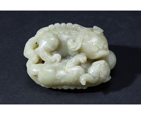 A NEPHRITE JADE CARVING OF LION CUBS
The carving modelled as two lion cubs with a ball

Accompanied by Nan Yang Gemological I