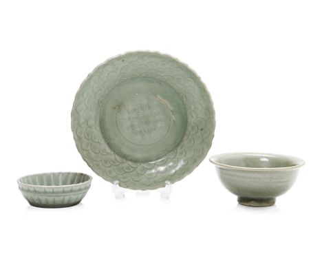 A GROUP OF THREE CELADON ITEMS
Comprising: a small bowl with fluted rim, the glaze degraded; a bowl,  with central floral mot