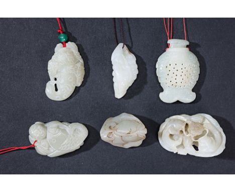 A GROUP OF SIX PALE CELADON JADE CARVINGS
To include fish around a lotus; a figure with a fish and bat; a twin fish small ves