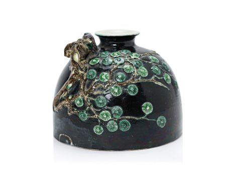 A RELIEF MOULDED FAMILLE NOIRE PORCELAIN WATER POT
In Kangxi style, the domed pot decorated in relief with an eagle perched o