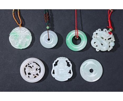 A GROUP OF SEVEN CARVED JADE DISCS AND PENDANTS
To include three plain discs; a dragon pendant; a Buddha pendant etc
The larg