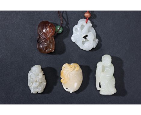 A GROUP OF FIVE JADE CARVINGS Comprising: a well carved pale celadon figure holding a fish; another figure holding a branch o