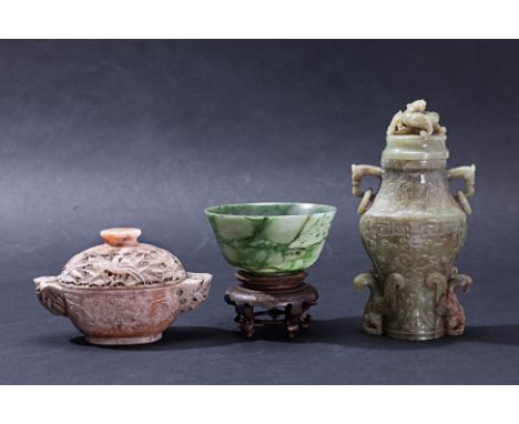 A GROUP OF THREE CHINESE STONE CARVINGS Comprising a green and russet vase and cover, decorated with archaic scrolls and with