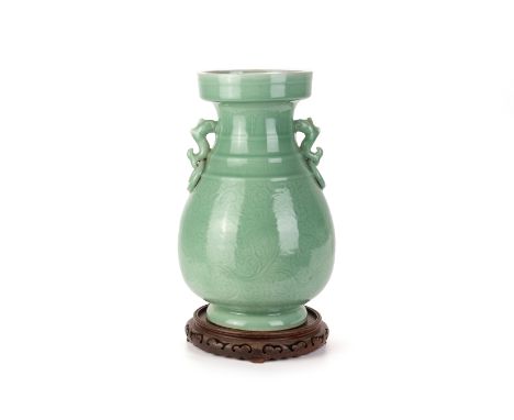 A LARGE INCISED TWIN HANDLED CELADON VASE
With straight rim and pear shaped body, twin stylised animal and ring handles, the 