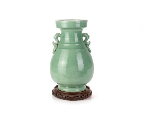 A LARGE INCISED TWIN HANDLED CELADON VASE
With straight rim and pear shaped body, twin stylised animal and ring handles, the 