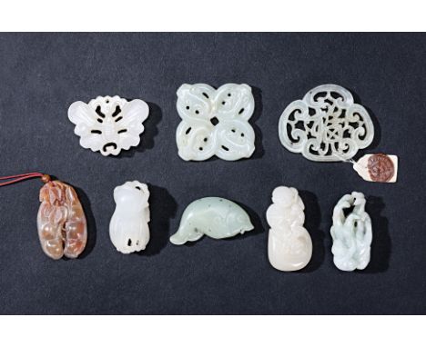 EIGHT ASSORTED JADE CARVINGS AND PENDANTS
To include a pierced plaque; a monkey climbing on a finger citron; a boy sat on a g