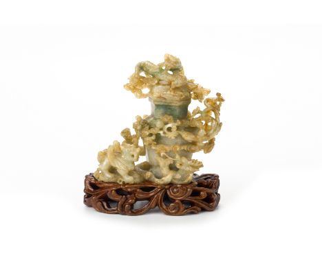 A CARVED JADE MYTHICAL BEAST VASE AND COVER
The elaborately carved vase with a design of mythical creatures around an hexagon