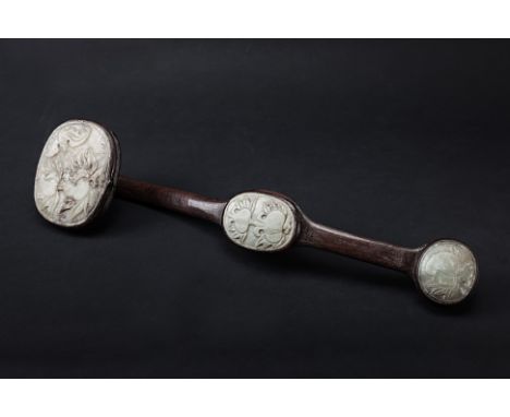 A JADE INSET CARVED WOOD RUYI SCEPTRE
The three jade panels carved with fruiting foliage
48cm long
Condition: For a condition