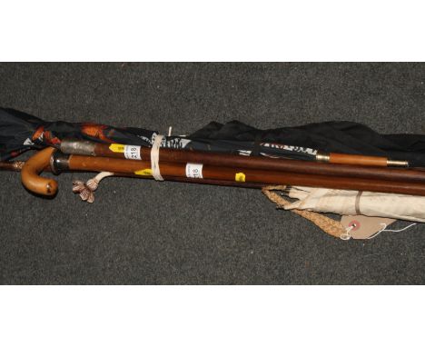 A palm wood walking cane with rolled gold mounts, a Royal Artillery swagger stick, a Malacca cane with silver mount, two meta