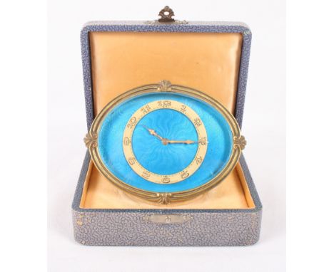An early 20th Century travel clock with blue enamelled dial, in fitted case, 3 1/4" high