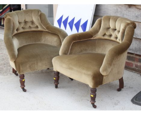 A pair of Victorian low seat occasional chairs, button upholstered in a green velour, on turned and castored supports