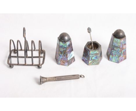 A silver four-division toast rack, an engine turned silver cigar piercer and a sterling silver and abalone mounted three-piec